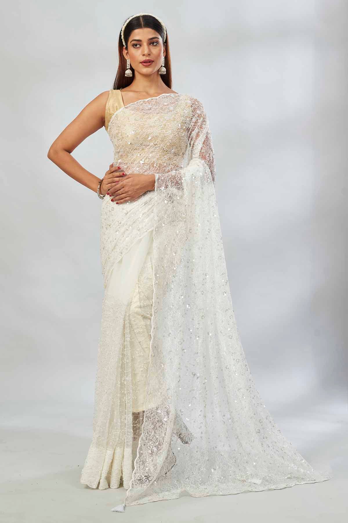Shop off-white sequin work net sari online in USA. Look your best on festive occasions in latest designer saris, pure silk saris, Kanjivaram silk sarees, handwoven saris, silk sarees, linen sarees,  embroidered sarees from Pure Elegance Indian clothing store in USA.-full view