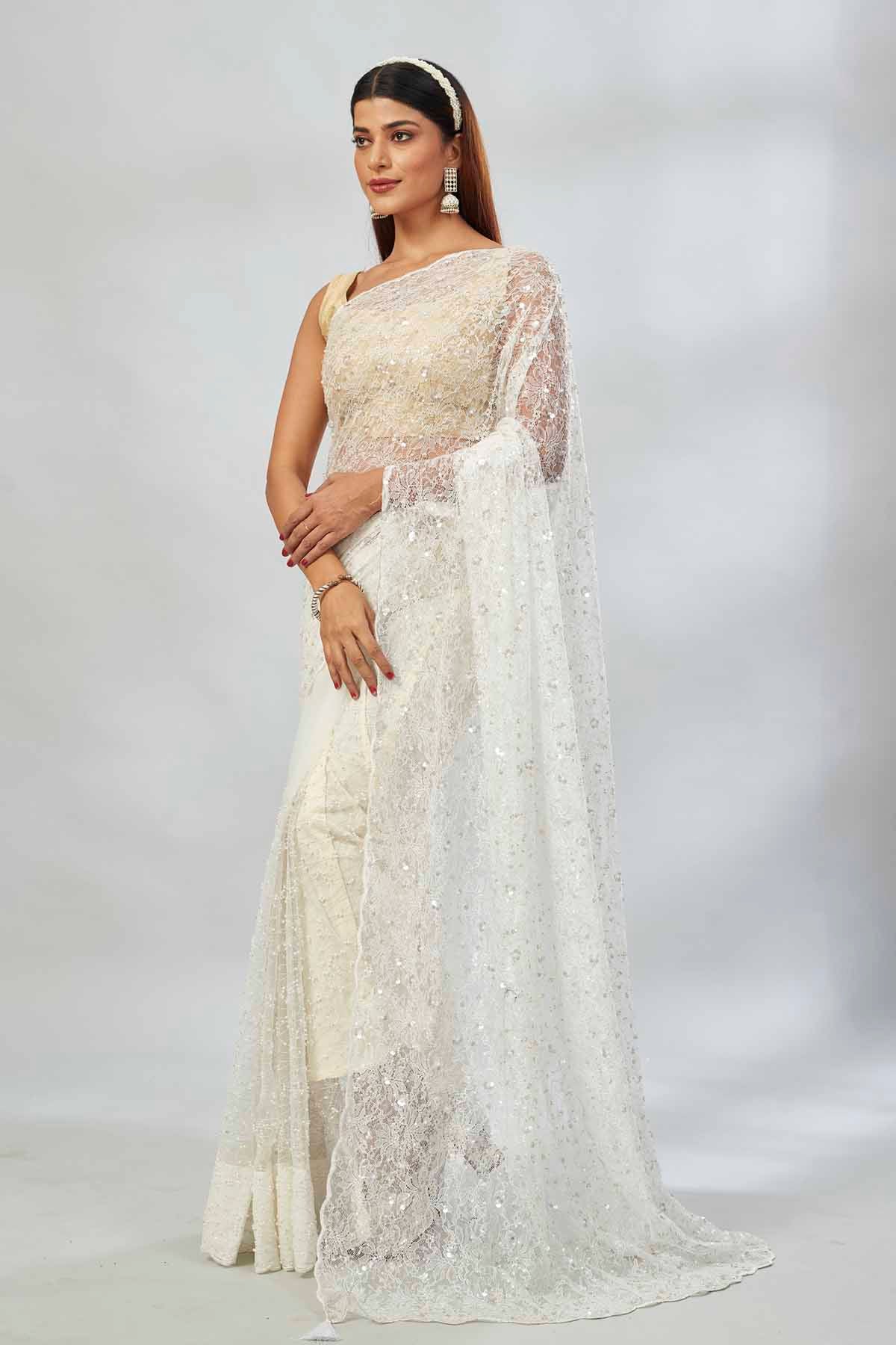 Shop off-white sequin work net sari online in USA. Look your best on festive occasions in latest designer saris, pure silk saris, Kanjivaram silk sarees, handwoven saris, silk sarees, linen sarees,  embroidered sarees from Pure Elegance Indian clothing store in USA.-pallu