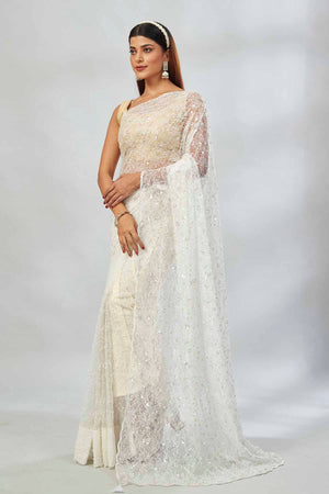 Shop off-white sequin work net sari online in USA. Look your best on festive occasions in latest designer saris, pure silk saris, Kanjivaram silk sarees, handwoven saris, silk sarees, linen sarees,  embroidered sarees from Pure Elegance Indian clothing store in USA.-pallu