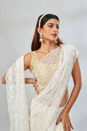Shop off-white sequin work net sari online in USA. Look your best on festive occasions in latest designer saris, pure silk saris, Kanjivaram silk sarees, handwoven saris, silk sarees, linen sarees,  embroidered sarees from Pure Elegance Indian clothing store in USA.-closeup