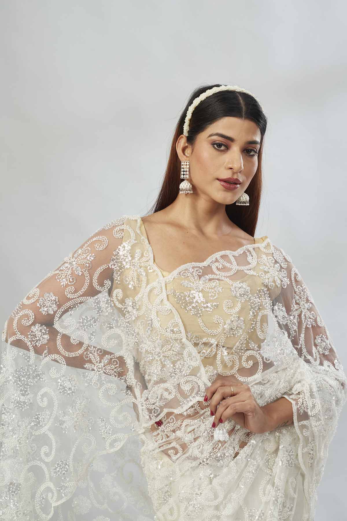 Buy off-white embroidered designer net sari online in USA. Look your best on festive occasions in latest designer saris, pure silk saris, Kanjivaram silk sarees, handwoven saris, silk sarees, linen sarees,  embroidered sarees from Pure Elegance Indian clothing store in USA.-closeup