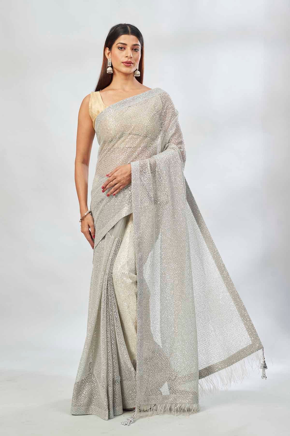 Buy light grey embroidered sequin net sari online in USA. Look your best on festive occasions in latest designer saris, pure silk saris, Kanjivaram silk sarees, handwoven saris, silk sarees, linen sarees,  embroidered sarees from Pure Elegance Indian clothing store in USA.-full view