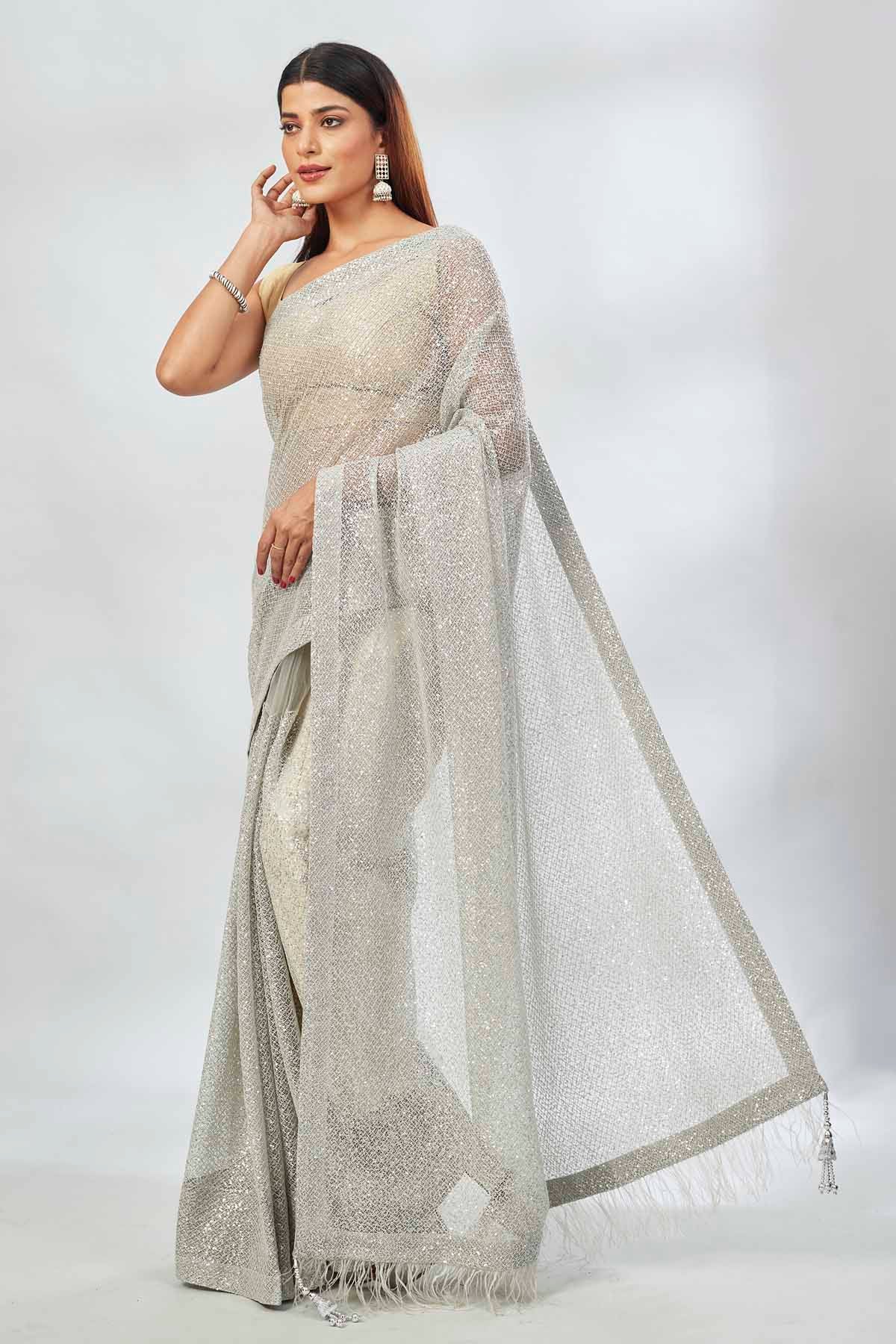 Buy light grey embroidered sequin net sari online in USA. Look your best on festive occasions in latest designer saris, pure silk saris, Kanjivaram silk sarees, handwoven saris, silk sarees, linen sarees,  embroidered sarees from Pure Elegance Indian clothing store in USA.-pallu