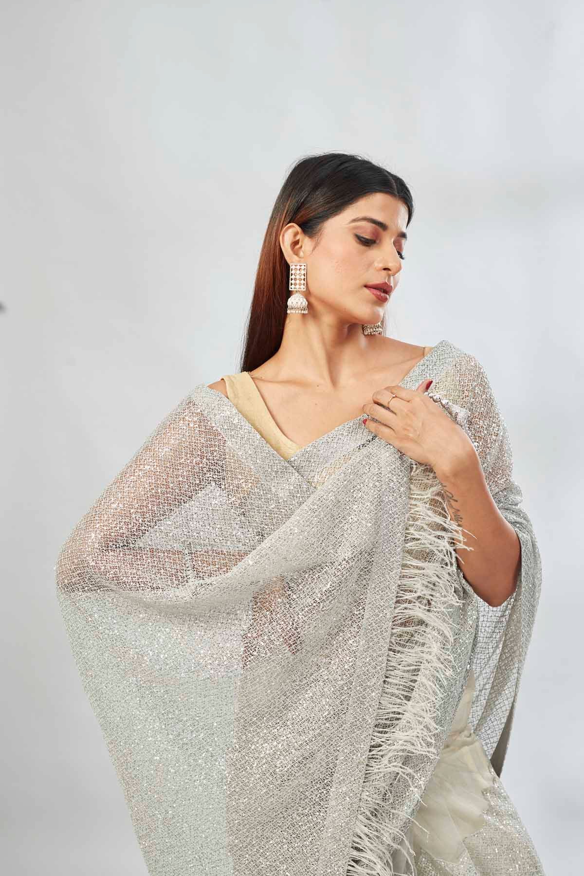 Buy light grey embroidered sequin net sari online in USA. Look your best on festive occasions in latest designer saris, pure silk saris, Kanjivaram silk sarees, handwoven saris, silk sarees, linen sarees,  embroidered sarees from Pure Elegance Indian clothing store in USA.-closeup