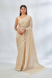 Shop stunning beige embroidered sequin net sari online in USA. Look your best on festive occasions in latest designer saris, pure silk saris, Kanjivaram silk sarees, handwoven saris, silk sarees, linen sarees,  embroidered sarees from Pure Elegance Indian clothing store in USA.-full view