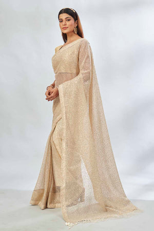 Shop stunning beige embroidered sequin net sari online in USA. Look your best on festive occasions in latest designer saris, pure silk saris, Kanjivaram silk sarees, handwoven saris, silk sarees, linen sarees,  embroidered sarees from Pure Elegance Indian clothing store in USA.-pallu
