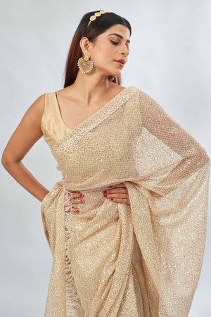 Shop stunning beige embroidered sequin net sari online in USA. Look your best on festive occasions in latest designer saris, pure silk saris, Kanjivaram silk sarees, handwoven saris, silk sarees, linen sarees,  embroidered sarees from Pure Elegance Indian clothing store in USA.-closeup