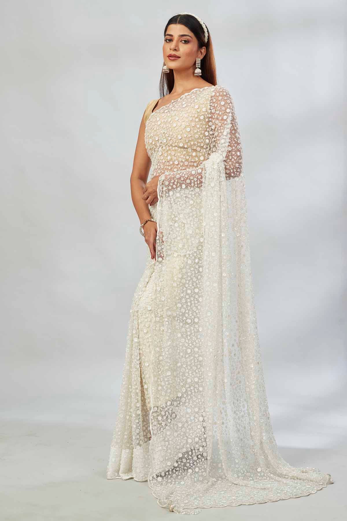 Shop cream embroidered net designer sari online in USA. Look your best on festive occasions in latest designer saris, pure silk saris, Kanjivaram silk sarees, handwoven saris, tussar silk sarees, linen sarees,  embroidered sarees from Pure Elegance Indian clothing store in USA.-pallu