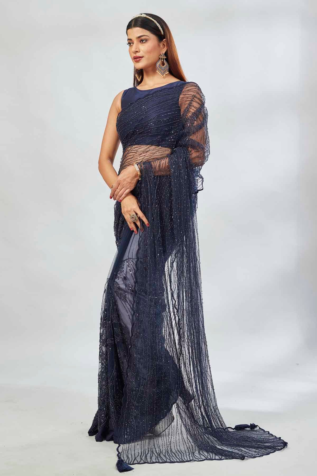 Buy stunning navy designer net sari online in USA with overall embroidery. Look your best on festive occasions in latest designer saris, pure silk saris, Kanjivaram silk sarees, handwoven saris, tussar silk sarees, linen sarees,  embroidered sarees from Pure Elegance Indian clothing store in USA.-pallu