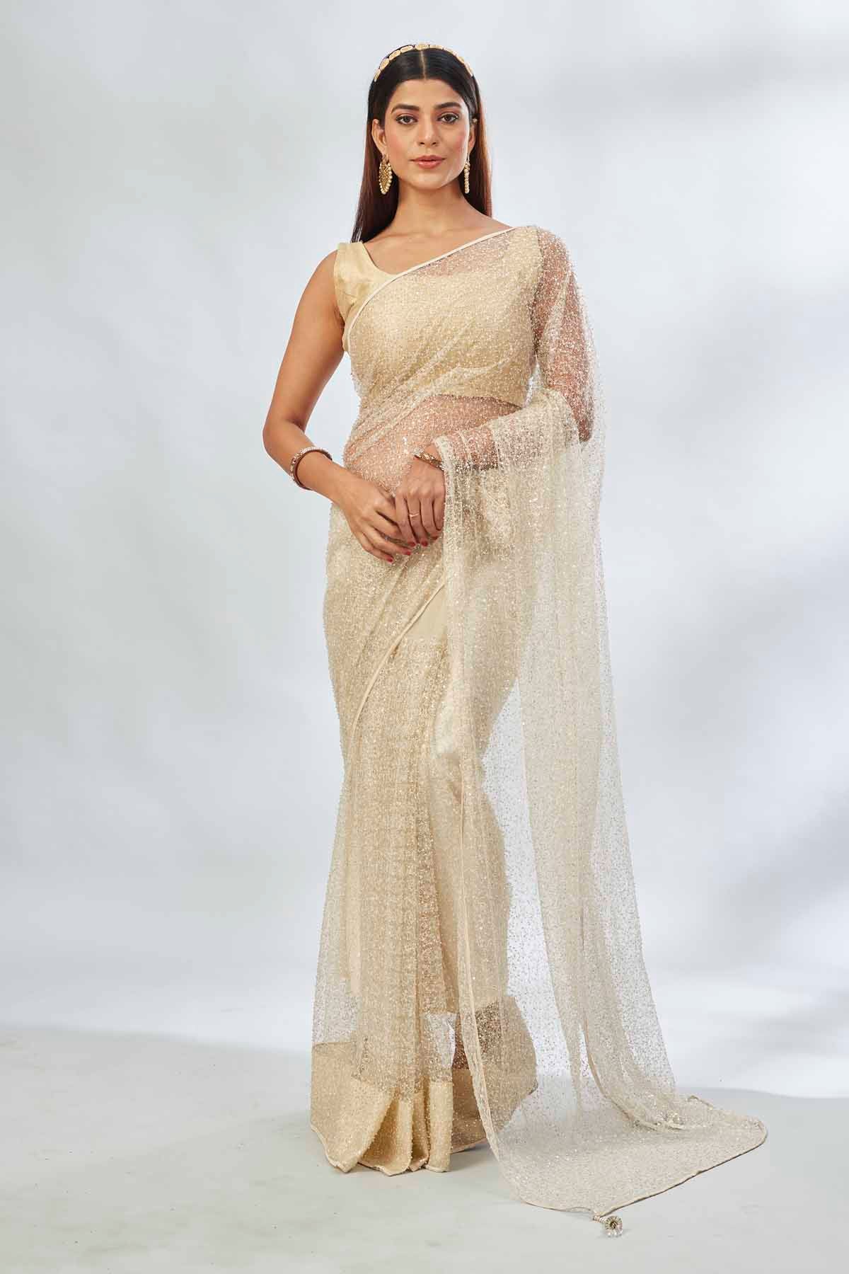 Buy cream designer net sari online in USA with overall embroidery. Look your best on festive occasions in latest designer saris, pure silk saris, Kanjivaram silk sarees, handwoven saris, tussar silk sarees, linen sarees,  embroidered sarees from Pure Elegance Indian clothing store in USA.-full view