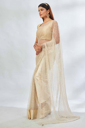 Buy cream designer net sari online in USA with overall embroidery. Look your best on festive occasions in latest designer saris, pure silk saris, Kanjivaram silk sarees, handwoven saris, tussar silk sarees, linen sarees,  embroidered sarees from Pure Elegance Indian clothing store in USA.-side
