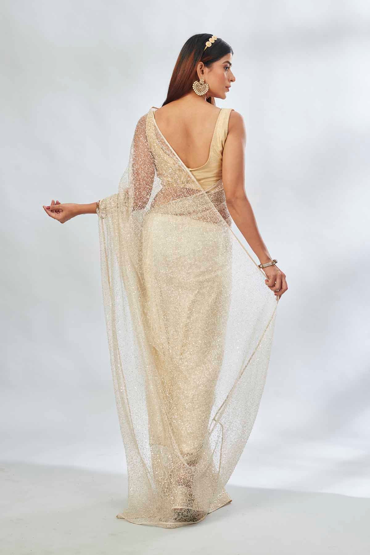 Buy cream designer net sari online in USA with overall embroidery. Look your best on festive occasions in latest designer saris, pure silk saris, Kanjivaram silk sarees, handwoven saris, tussar silk sarees, linen sarees,  embroidered sarees from Pure Elegance Indian clothing store in USA.-back