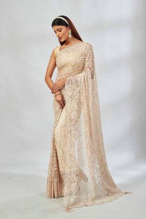Buy cream embroidered designer lace sari online in USA. Look your best on festive occasions in latest designer saris, pure silk saris, Kanjivaram silk sarees, handwoven saris, tussar silk sarees, linen sarees,  embroidered sarees from Pure Elegance Indian clothing store in USA.-pallu