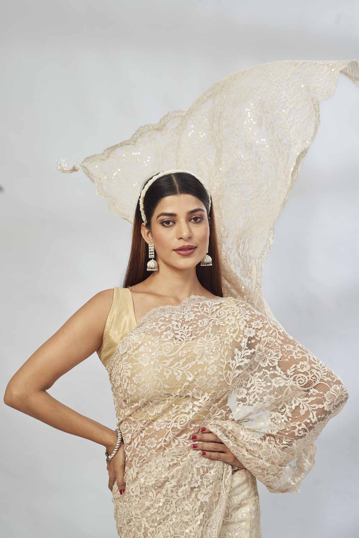 Buy cream embroidered designer lace sari online in USA. Look your best on festive occasions in latest designer saris, pure silk saris, Kanjivaram silk sarees, handwoven saris, tussar silk sarees, linen sarees,  embroidered sarees from Pure Elegance Indian clothing store in USA.-closeup