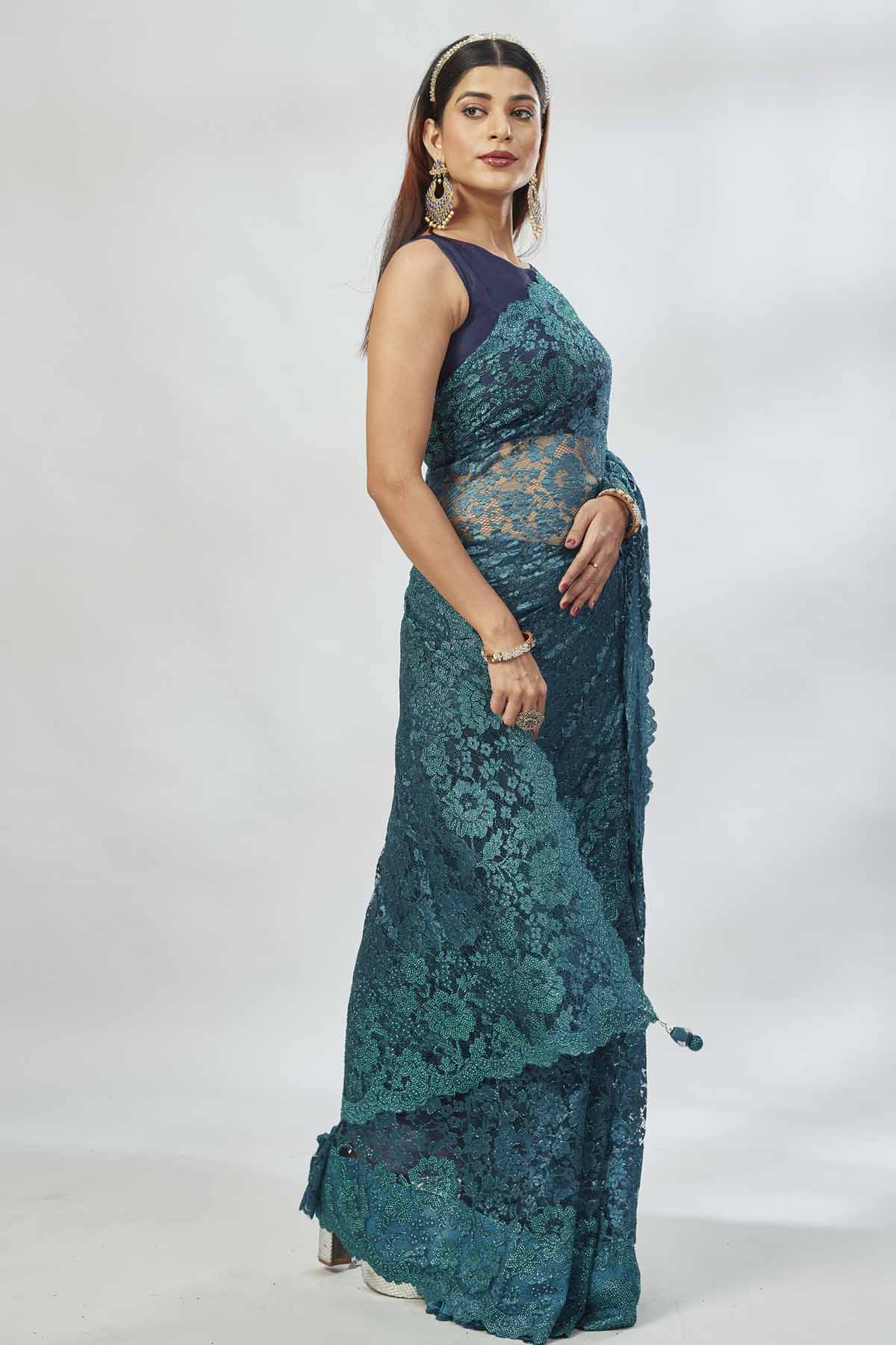 Shop stunning teal embroidered lace saree online in USA. Look your best on festive occasions in latest designer saris, pure silk saris, Kanjivaram silk sarees, handwoven saris, tussar silk sarees, linen sarees,  embroidered sarees from Pure Elegance Indian clothing store in USA.-side