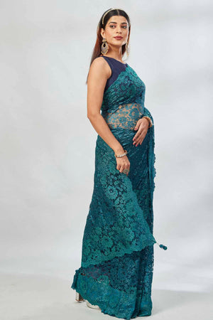 Shop stunning teal embroidered lace saree online in USA. Look your best on festive occasions in latest designer saris, pure silk saris, Kanjivaram silk sarees, handwoven saris, tussar silk sarees, linen sarees,  embroidered sarees from Pure Elegance Indian clothing store in USA.-side