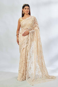 Shop elegant cream embroidered lace saree online in USA. Look your best on festive occasions in latest designer saris, pure silk saris, Kanjivaram silk sarees, handwoven saris, tussar silk sarees, linen sarees,  embroidered sarees from Pure Elegance Indian clothing store in USA.-full view