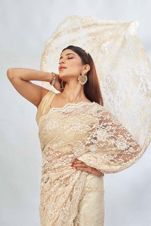 Shop elegant cream embroidered lace saree online in USA. Look your best on festive occasions in latest designer saris, pure silk saris, Kanjivaram silk sarees, handwoven saris, tussar silk sarees, linen sarees,  embroidered sarees from Pure Elegance Indian clothing store in USA.-closeup