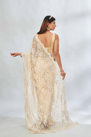 Shop elegant cream embroidered lace saree online in USA. Look your best on festive occasions in latest designer saris, pure silk saris, Kanjivaram silk sarees, handwoven saris, tussar silk sarees, linen sarees,  embroidered sarees from Pure Elegance Indian clothing store in USA.-back