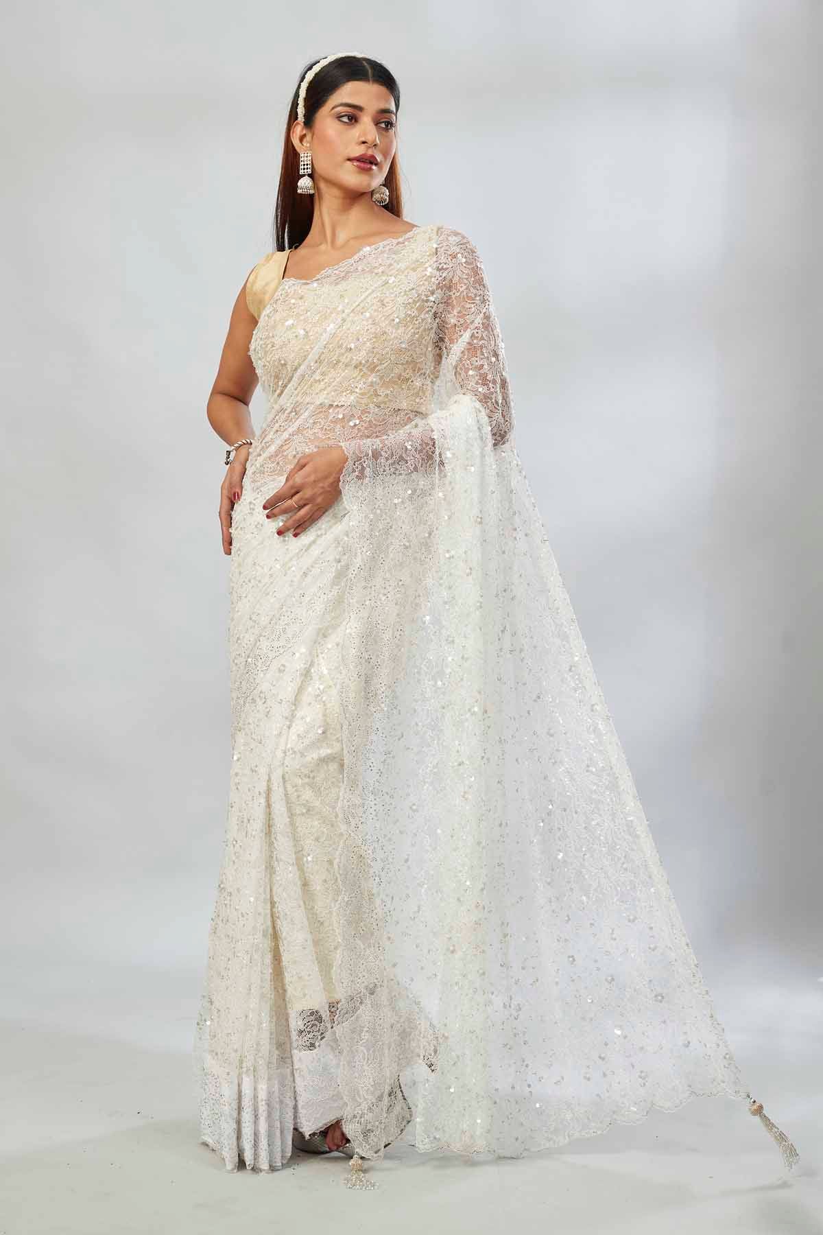 Buy white embroidered lace net designer saree online in USA with blouse. Look your best on festive occasions in latest designer saris, pure silk saris, Kanjivaram silk sarees, handwoven saris, tussar silk sarees, linen sarees,  embroidered sarees from Pure Elegance Indian clothing store in USA.-full view