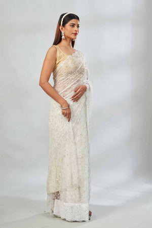 Buy white embroidered lace net designer saree online in USA with blouse. Look your best on festive occasions in latest designer saris, pure silk saris, Kanjivaram silk sarees, handwoven saris, tussar silk sarees, linen sarees,  embroidered sarees from Pure Elegance Indian clothing store in USA.-side