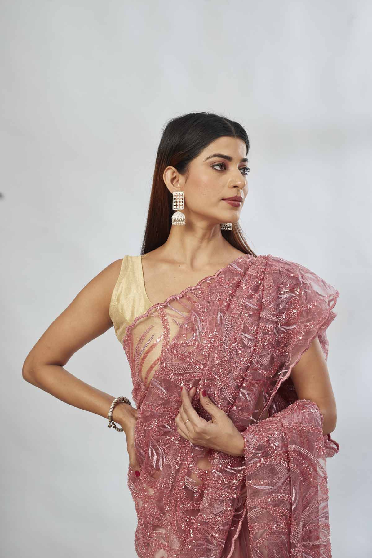 Shop dusty pink embroidered lace net saree online in USA with blouse. Look your best on festive occasions in latest designer saris, pure silk saris, Kanjivaram silk sarees, handwoven saris, tussar silk sarees, linen sarees,  embroidered sarees from Pure Elegance Indian clothing store in USA.-closeup
