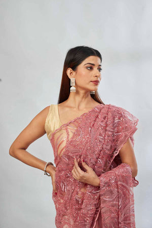 Shop dusty pink embroidered lace net saree online in USA with blouse. Look your best on festive occasions in latest designer saris, pure silk saris, Kanjivaram silk sarees, handwoven saris, tussar silk sarees, linen sarees,  embroidered sarees from Pure Elegance Indian clothing store in USA.-closeup