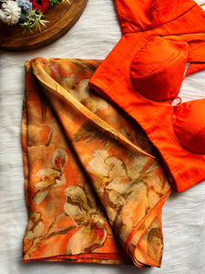 Shop beautiful orange floral shimmer georgette saree online in USA with blouse. Look your best on festive occasions in latest designer saris, pure silk saris, Kanjivaram silk sarees, handwoven saris, tussar silk sarees, linen sarees,  summer sarees from Pure Elegance Indian clothing store in USA.-full view