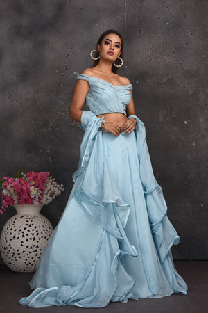 Buy beautiful powder blue off-shoulder lehenga online in USA with ruffle dupatta. Look your best at weddings and special occasions in exclusive designer lehengas, Anarkali suits, sharara suits. designer gowns and Indian dresses from Pure Elegance Indian fashion store in USA.-side