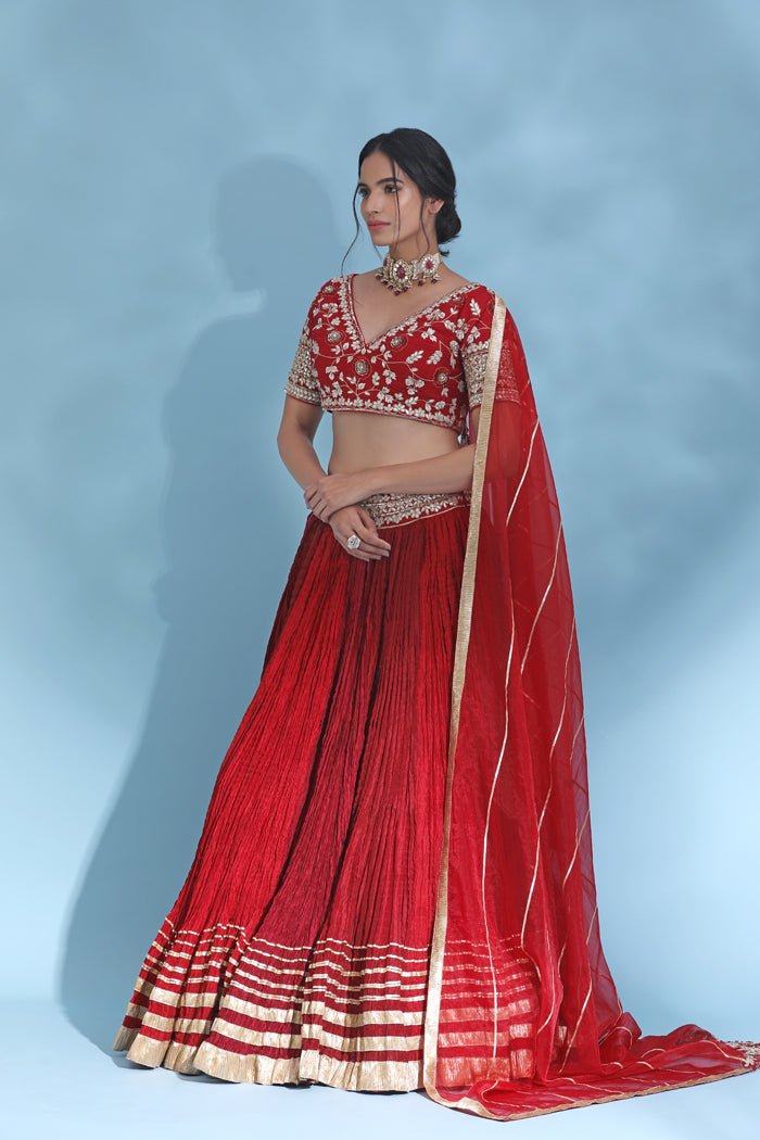 Shop stunning red gota work designer lehenga online in USA with dupatta. Look your best at weddings and parties in Indian dresses, designer lehengas, Anarkali suits, designer gowns, salwar suits, sharara suits from Pure Elegance Indian fashion store in USA.-side