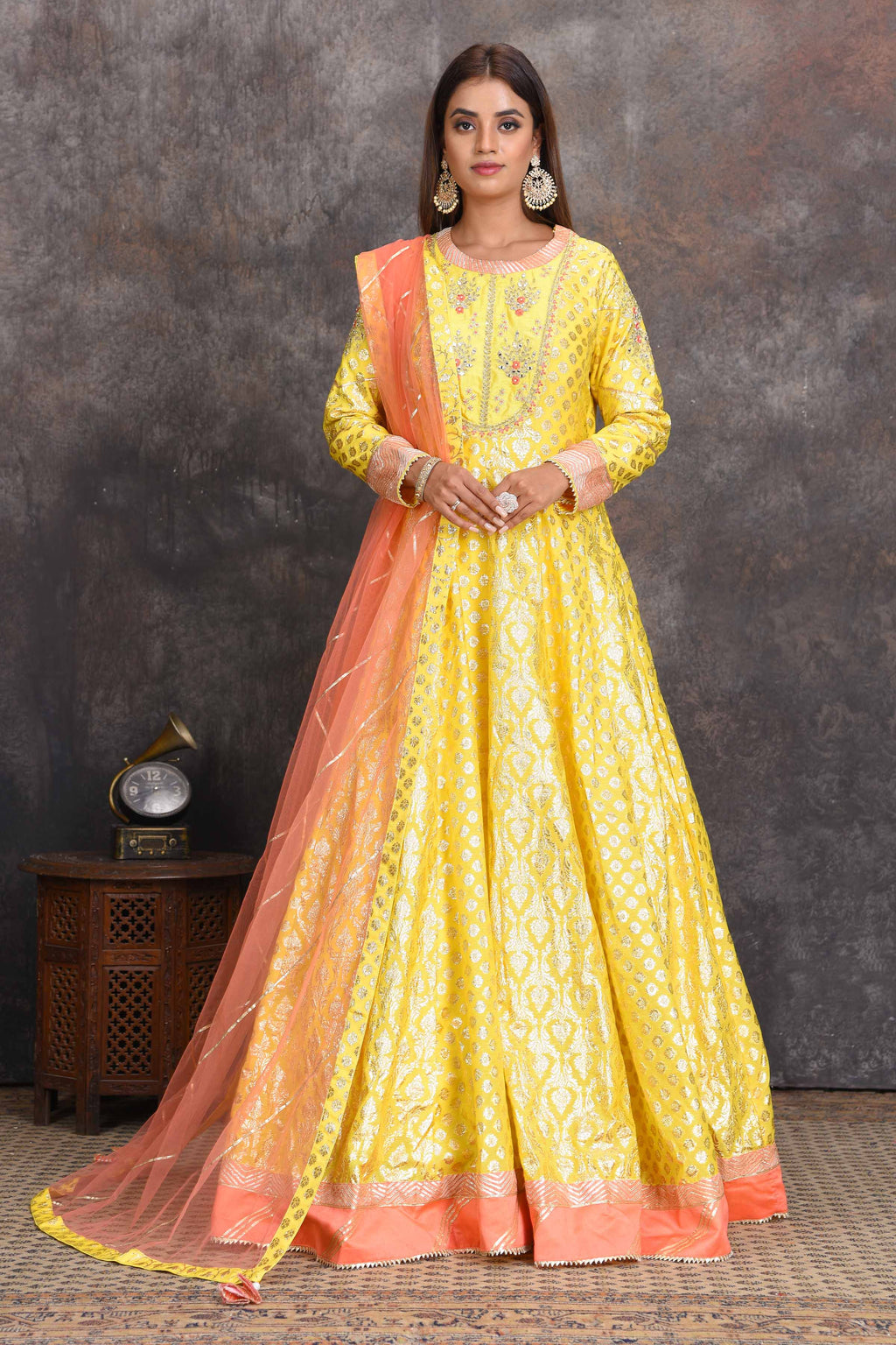 Buy bright yellow chanderi Banarasi Anarkali online in USA with peach dupatta. Set a style statement on special occasions in exquisite designer lehengas, Anarkali suits, sharara suits, salwar suits, Indowestern outfits from Pure Elegance Indian fashion store in USA.-full view