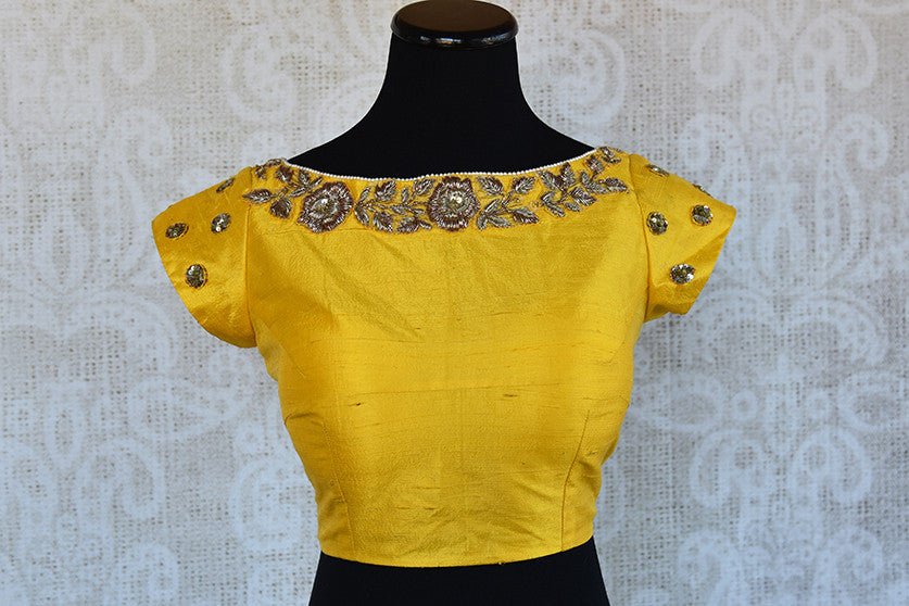 Very Beautiful yellow designer blouse which has embroidery on neck line and sleeves and also in the back can be bought in store USA. Mix and match with sarees.-front