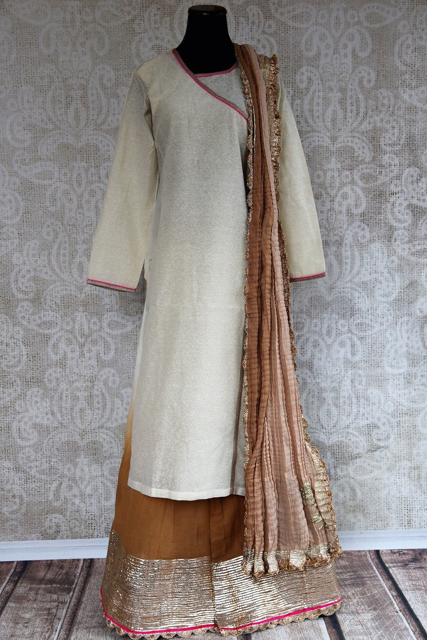 Buy this beautiful silk indian suit of beige kurti and brown palazzo pants with gold border and dupatta from pure elegance store. Great for casual occasions- Full View with Dupatta