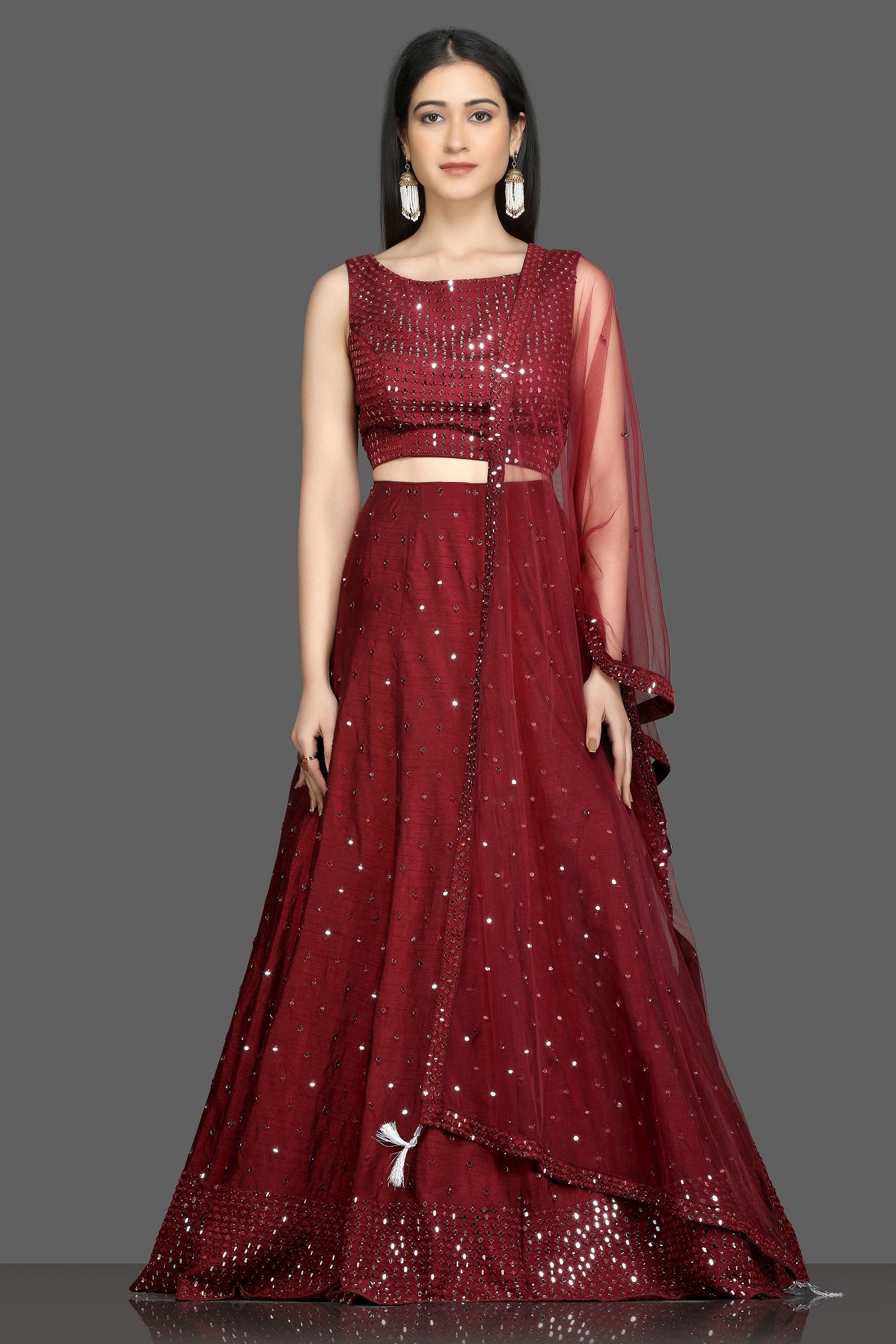 Buy wine color mirror work designer lehenga online in USA with net dupatta. Flaunt your sartorial choices on special occasions with beautiful designer gowns, Anarkali suits, traditional salwar suits, Indian lehengas from Pure Elegance Indian fashion boutique in USA. -full view