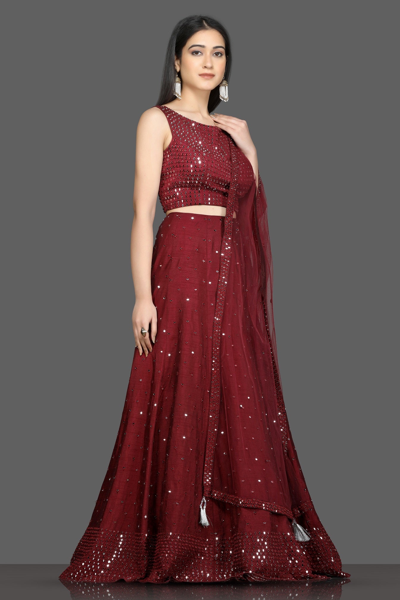 Buy wine color mirror work designer lehenga online in USA with net dupatta. Flaunt your sartorial choices on special occasions with beautiful designer gowns, Anarkali suits, traditional salwar suits, Indian lehengas from Pure Elegance Indian fashion boutique in USA. -right