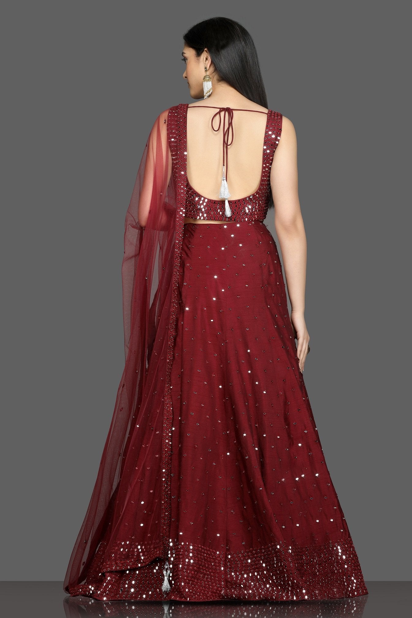 Buy wine color mirror work designer lehenga online in USA with net dupatta. Flaunt your sartorial choices on special occasions with beautiful designer gowns, Anarkali suits, traditional salwar suits, Indian lehengas from Pure Elegance Indian fashion boutique in USA. -back