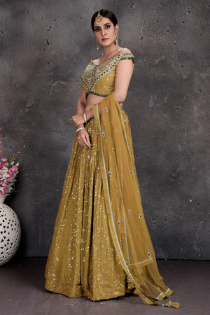 Yellow flowy lehenga with off-shoulder blouse by Izzumi Mehta