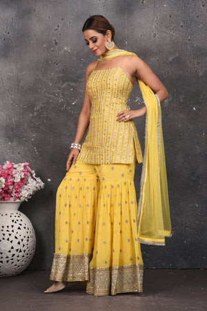 Shop beautiful light yellow embroidered designer gharara suit online in USA with dupatta. Look your best at weddings and special occasions in exclusive designer lehengas, Anarkali suits, sharara suits. designer gowns and Indian dresses from Pure Elegance Indian fashion store in USA.-gharara