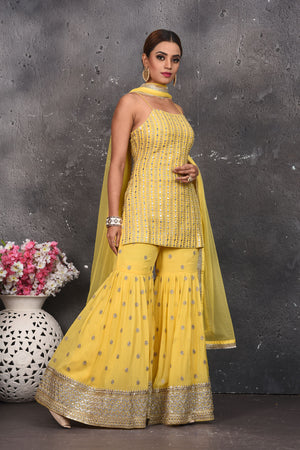 Shop beautiful light yellow embroidered designer gharara suit online in USA with dupatta. Look your best at weddings and special occasions in exclusive designer lehengas, Anarkali suits, sharara suits. designer gowns and Indian dresses from Pure Elegance Indian fashion store in USA.-side