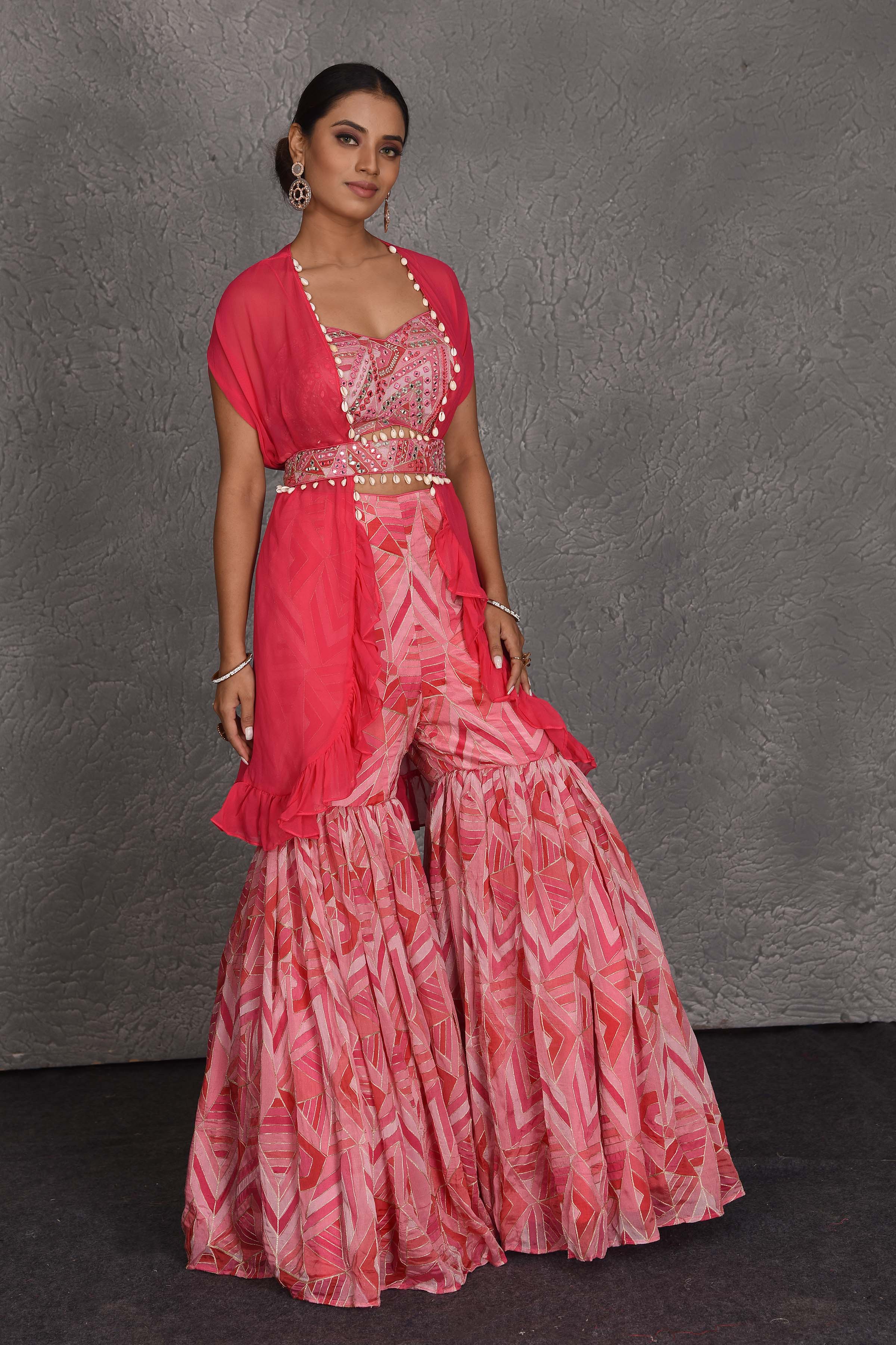 Shop pink printed sharara suit online in USA with shrug and belt. Flaunt your Indian style on festive occasions in stunning designer lehengas, Anarkali suit, sharara suits, designer gowns, designer sarees, embroidered sarees from Pure Elegance India fashion store in USA. -side