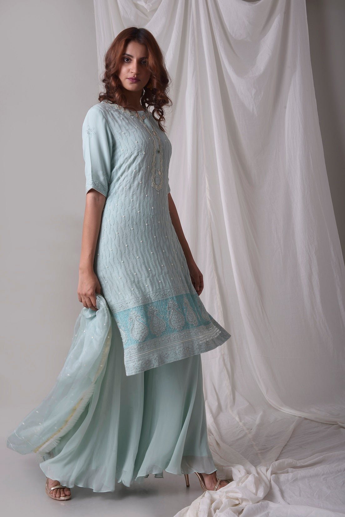 Buy sky blue georgette suit online in USA with palazzo and dupatta. Be the talk of parties and weddings with exquisite designer gowns, Indian suits, Anarkali dresses, Indo-western dresses from Pure Elegance Indian clothing store in USA .Shop online now.-side view