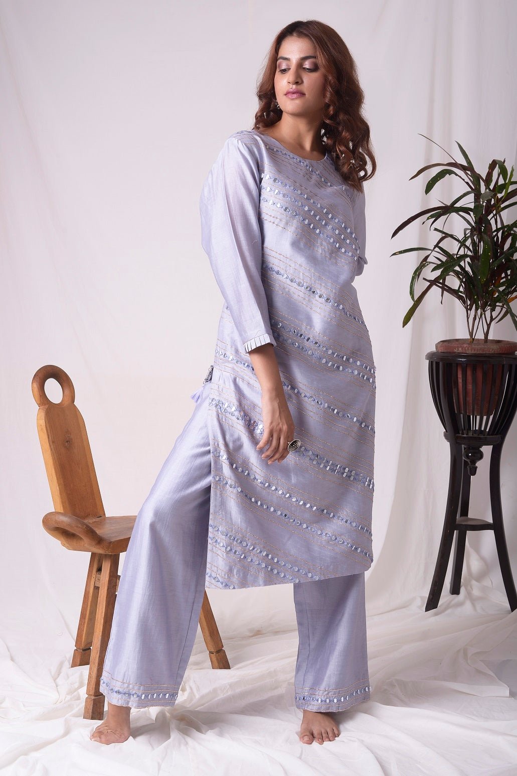 Buy elegant lavender chanderi suit online in USA. Suit has simple silver design work. It has 3/4 length sleeves with delicate design and complementing palazzo. Simple look makes it elegant. Be the talk of parties and weddings with exquisite designer gowns from Pure Elegance Indian clothing store in USA. -full view