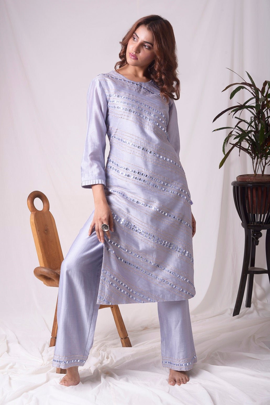 Buy elegant lavender chanderi suit online in USA. Suit has simple silver design work. It has 3/4 length sleeves with delicate design and complementing palazzo. Simple look makes it elegant. Be the talk of parties and weddings with exquisite designer gowns from Pure Elegance Indian clothing store in USA.-full view-3