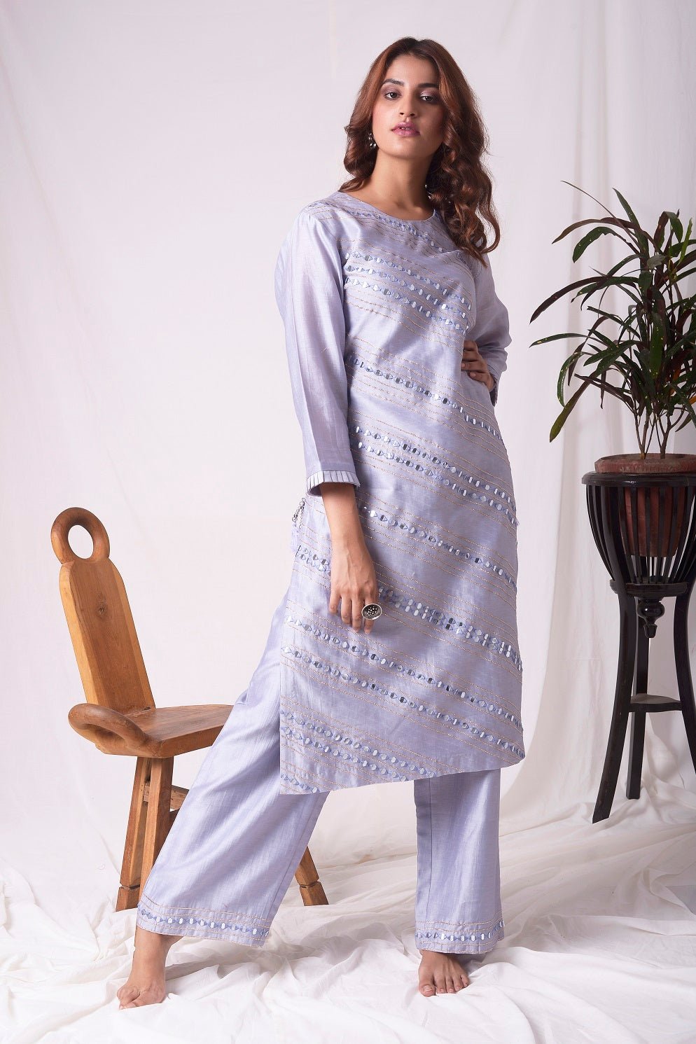 Buy elegant lavender chanderi suit online in USA. Suit has simple silver design work. It has 3/4 length sleeves with delicate design and complementing palazzo. Simple look makes it elegant. Be the talk of parties and weddings with exquisite designer gowns from Pure Elegance Indian clothing store in USA. -full view-4