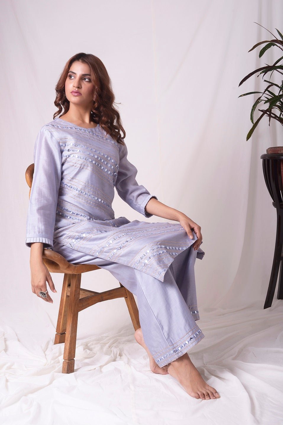 Buy elegant lavender chanderi suit online in USA. Suit has simple silver design work. It has 3/4 length sleeves with delicate design and complementing palazzo. Simple look makes it elegant. Be the talk of parties and weddings with exquisite designer gowns from Pure Elegance Indian clothing store in USA. -full view-5