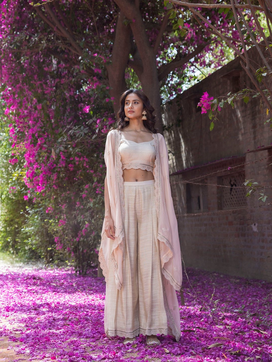 Shop beautiful peach crop top with palazzo and organza cape online in USA. Dazzle on weddings and special occasions with exquisite Indian designer dresses, sharara suits, Anarkali suits, wedding lehengas from Pure Elegance Indian fashion store in USA.-front