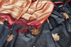 Shop black borderless tussar Benarasi saree online in USA with golden floral buta. Shine bright in best of Indian designer sarees from Pure Elegance Indian fashion store in USA on special occasions. Choose from a splendid variety of Banarasi sarees, pure handwoven saris. Shop online.-details