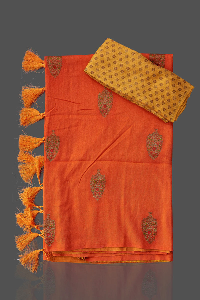 Shop stunning orange and yellow borderless muga Benarasi saree online in USA with antique zari buta. Shop beautiful Banarasi sarees, georgette sarees, pure muga silk sarees in USA from Pure Elegance Indian fashion boutique in USA. Get spoiled for choices with a splendid variety of Indian saris to choose from! Shop now.-details