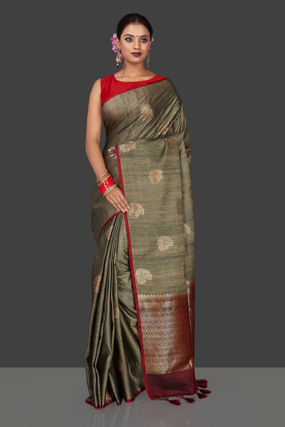 Buy elegant striped grey borderless tussar Banarasi saree online in USA with antique zari buta. Garner compliments on weddings and special occasions with exquisite Banarasi saris, handwoven silk sarees, tussar sarees from Pure Elegance Indian fashion store in USA.-front