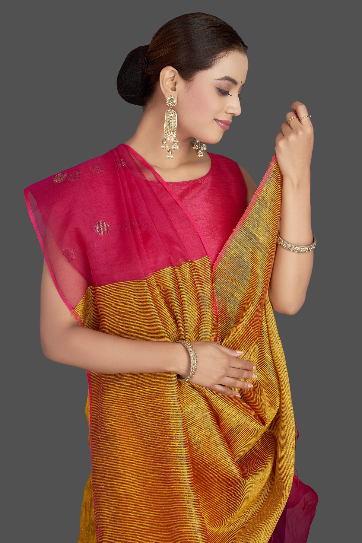 Buy stunning yellow and pink matka muslin saree online in USA with bali buti. Look gorgeous on special occasions with exquisite Indian sarees, handwoven sarees, Banarasi sarees, pure silk sarees from Pure Elegance Indian saree store in USA.-closeup